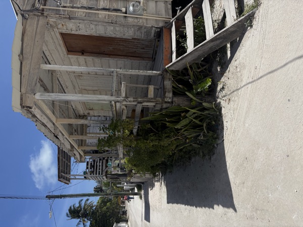 Wooden house on a sand street